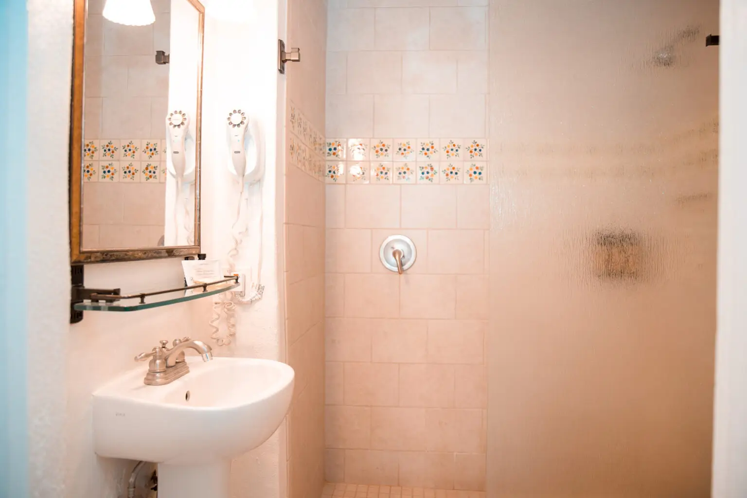 Single full room ensuite shower with sink and vanity