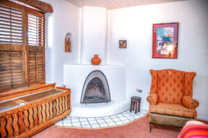 Standard king room with seating area, fireplace, and wood furniture