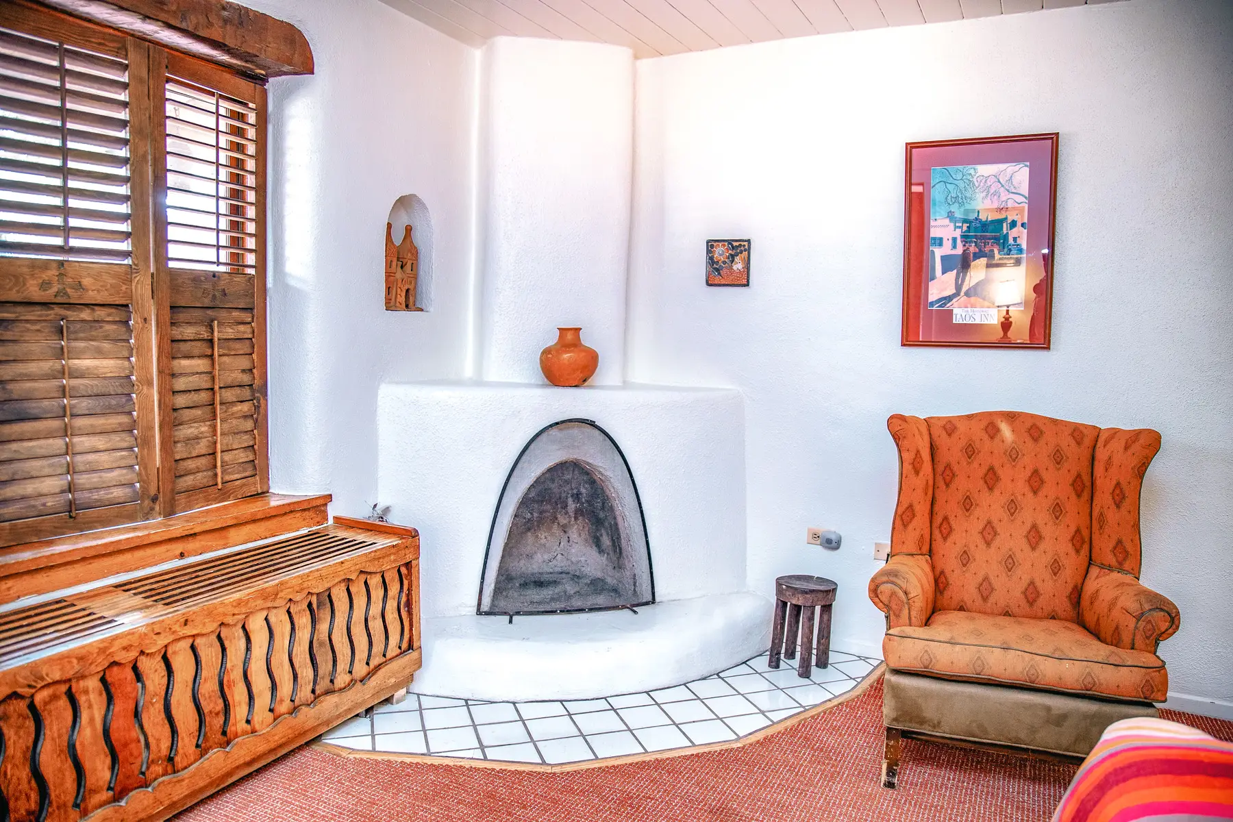 Standard king room with seating area, fireplace, and wood furniture