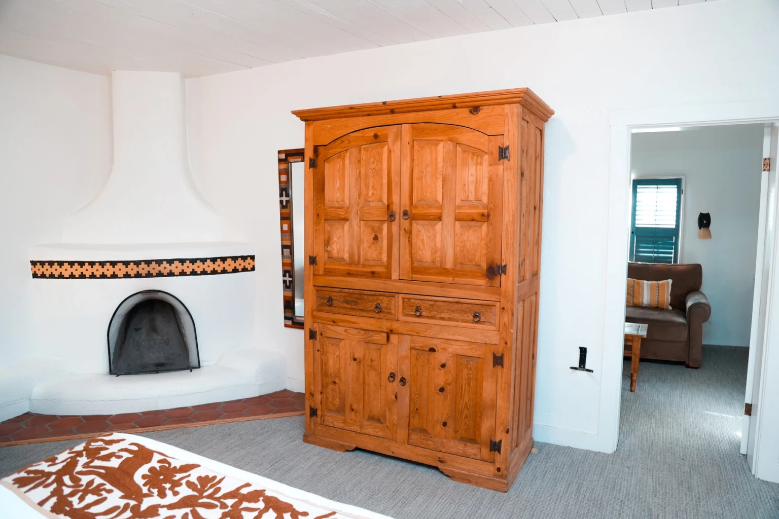 Fireplace, wardrobe, and seating in king suite