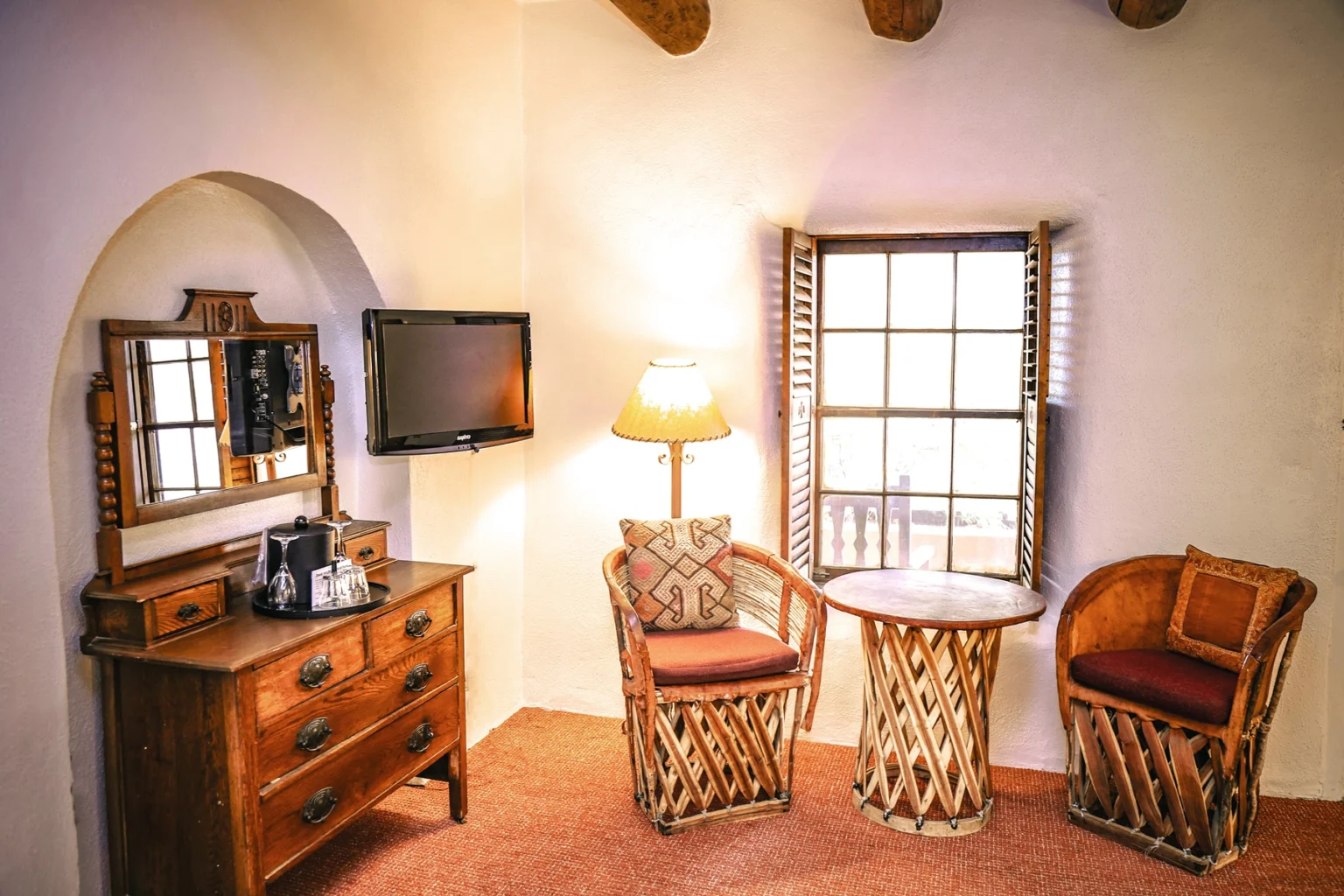 Seating area and dresser in standard queen room