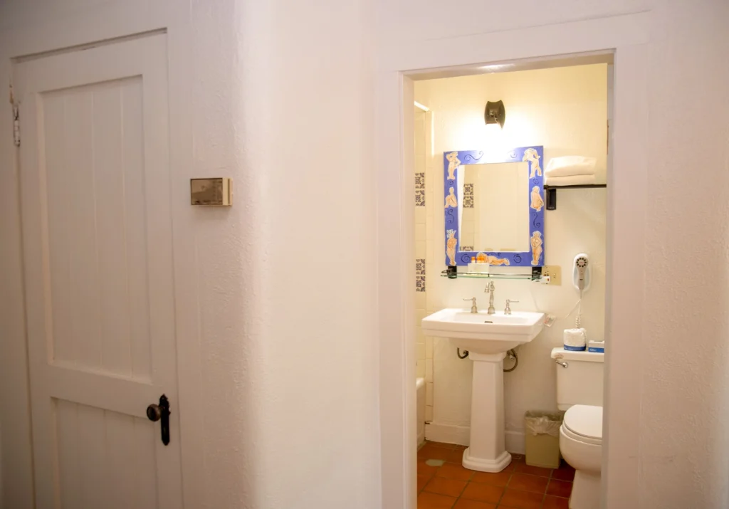 Bathroom sink and vanity with toilet in standard two full room