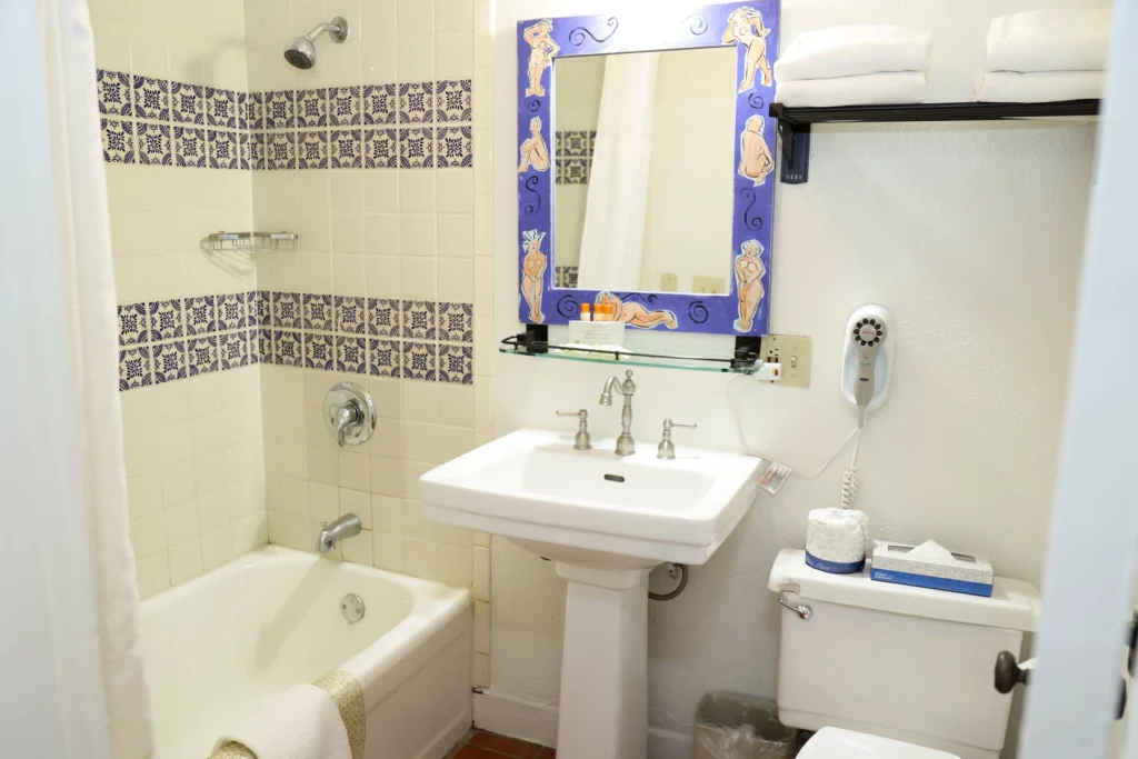 Bathroom sink and vanity, bathtub, with toilet in standard two full room