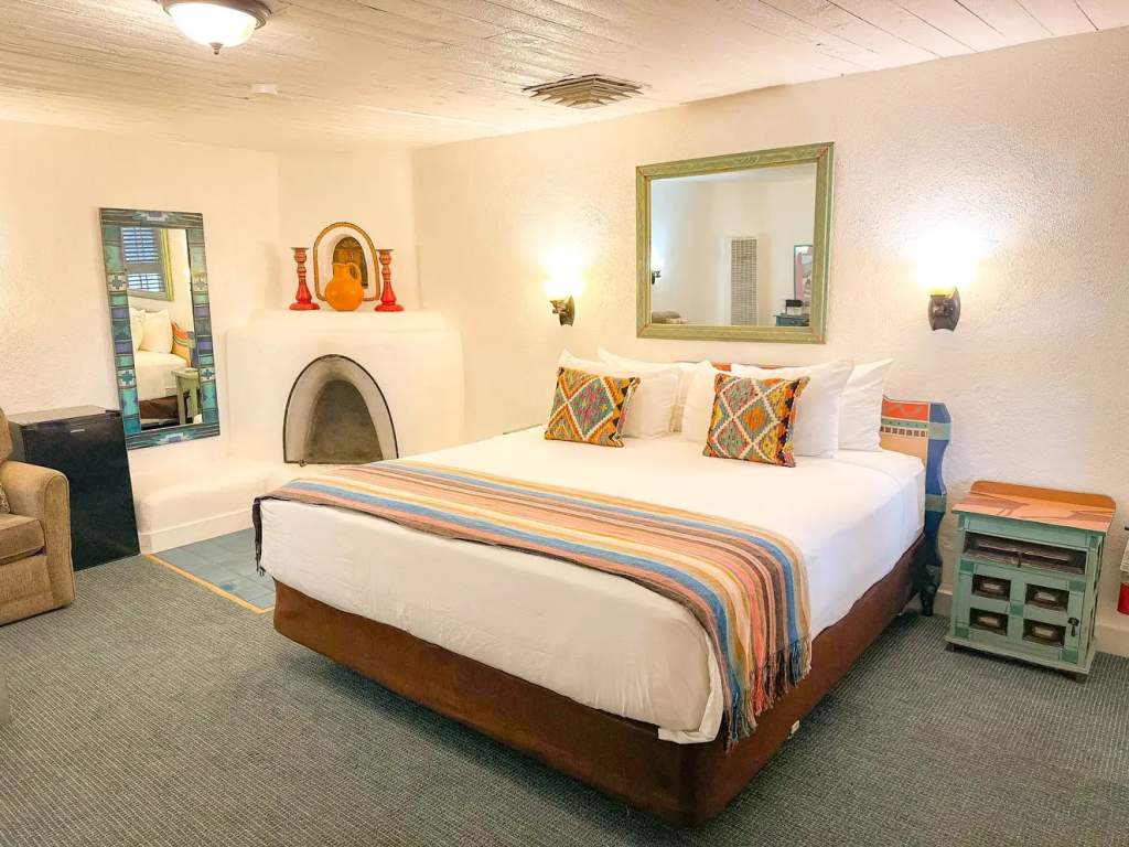 Bed in deluxe king room with fireplace