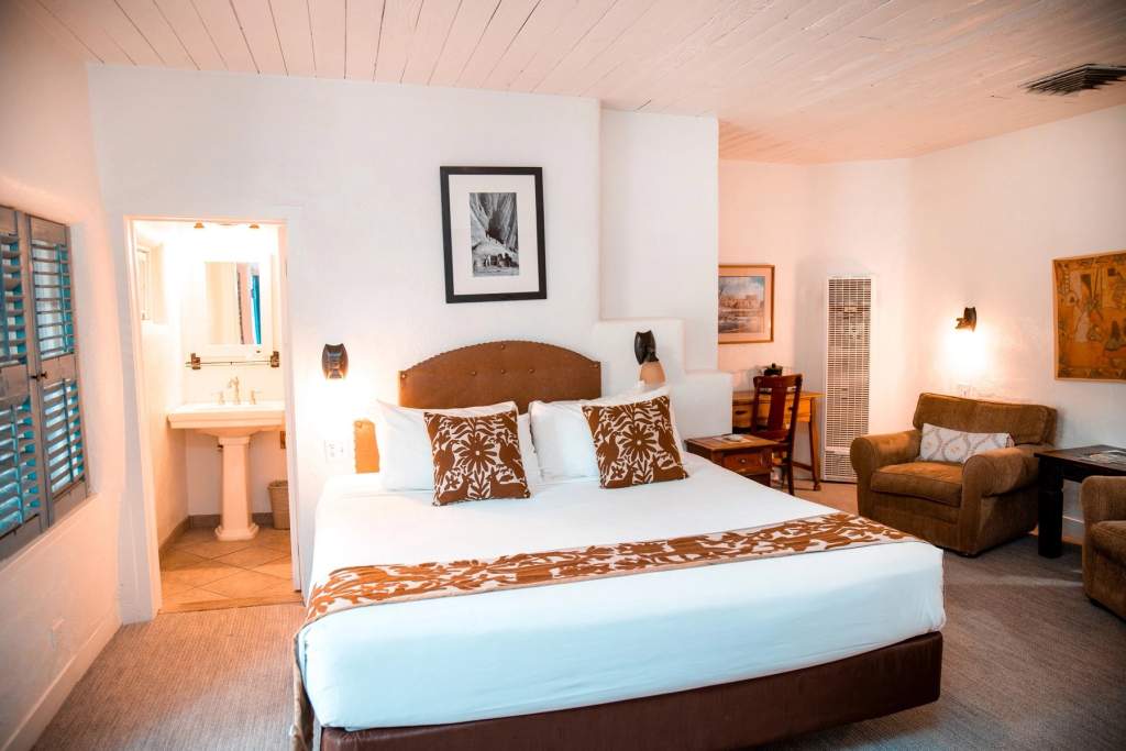Bed, desk, and seating in king suite