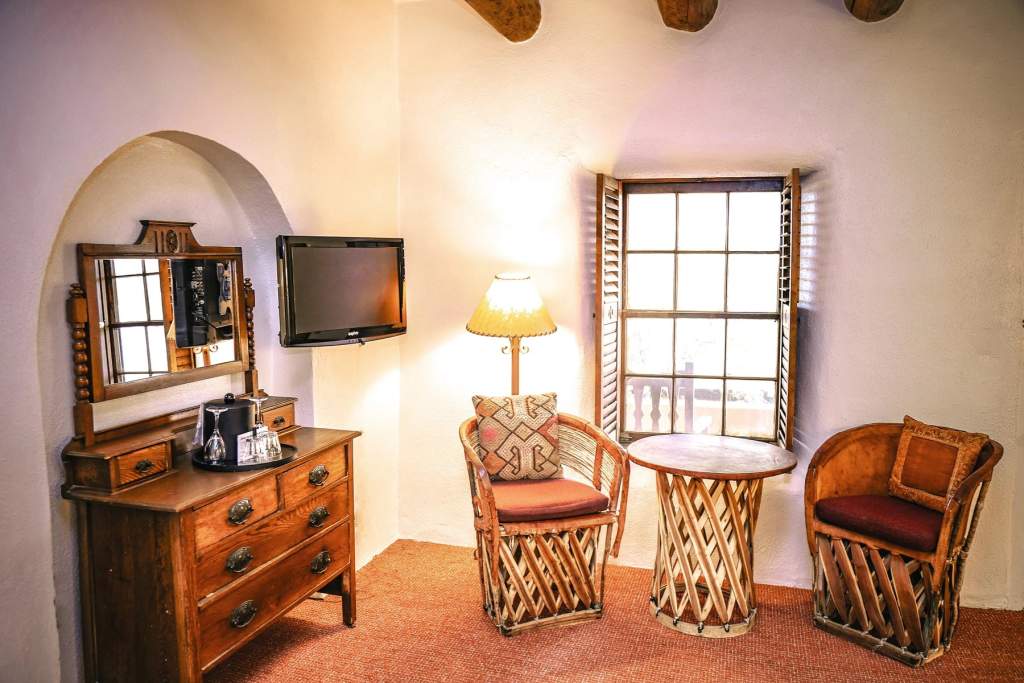 Bed in standard queen room with fireplace