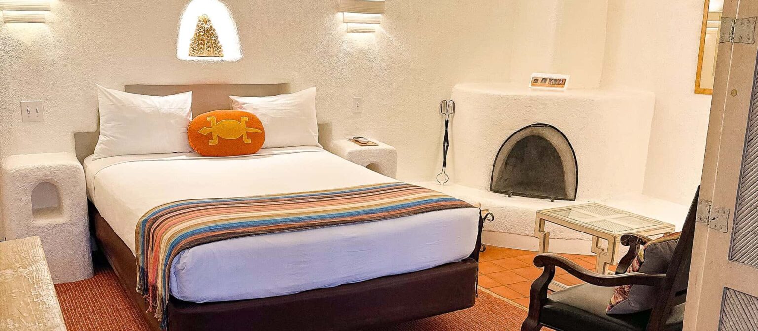 Bed, fireplace, and seating in queen suite