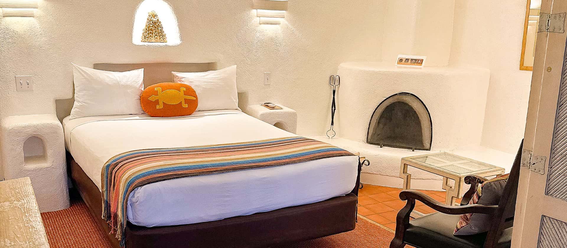 Bed, fireplace, and seating in queen suite