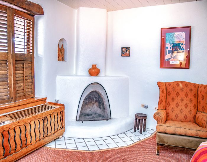 Standard king room with seating area, fireplace, and wood furniture