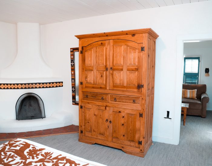 Fireplace, wardrobe, and seating in king suite