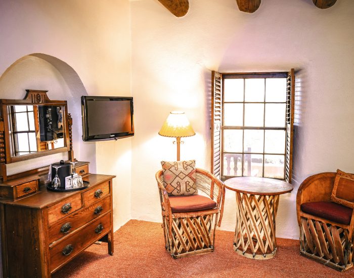 Seating area and dresser in standard queen room