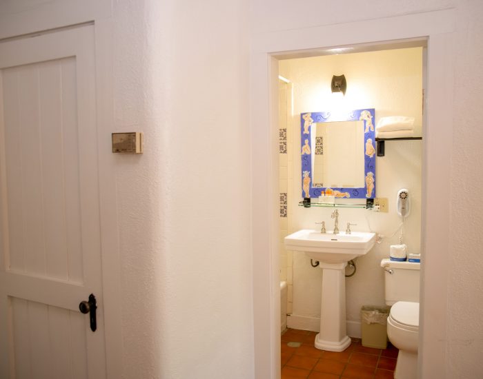 Bathroom sink and vanity, with toilet in standard two full room